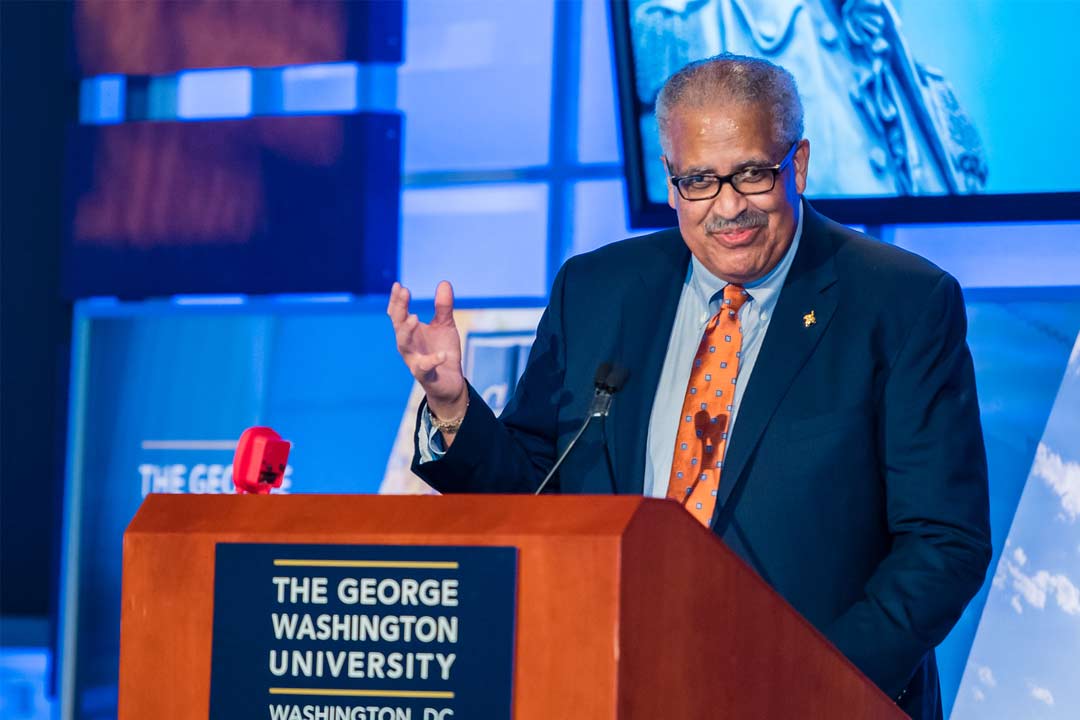 Cropped image of Jim Robinson at a GW Podium speaking