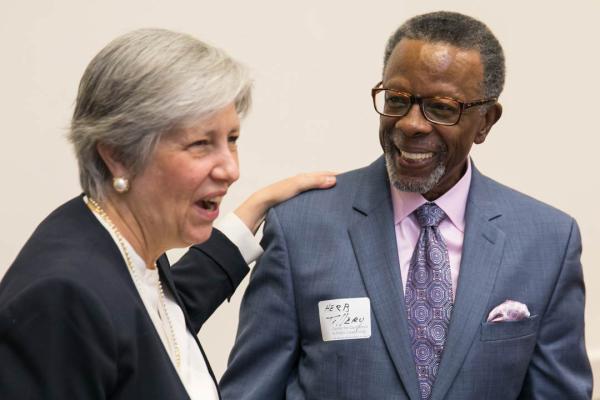 GW CEPL Senior Fellow Dr. Kari Moe gives a warm hug to the Center's former Executive Director Herb Tillery