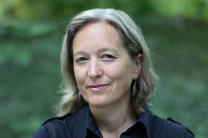 Photo of a woman with collar length hair looking at the camera
