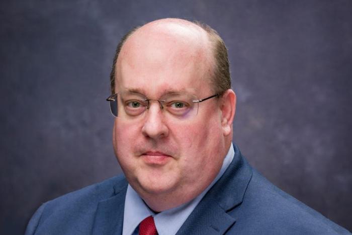 Man in a blue suit with a red tie