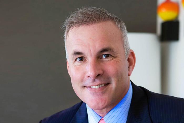 Man in blue suit with pink tie 