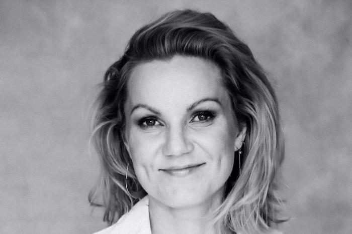 Woman with a white shirt smiling 