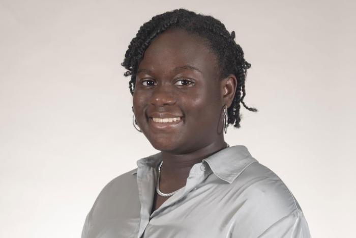 Woman with pink shirt and broad smile