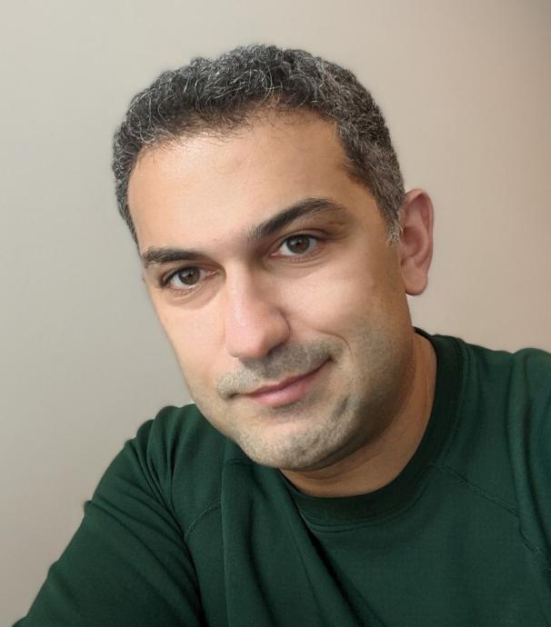Man with dark shirt smiling